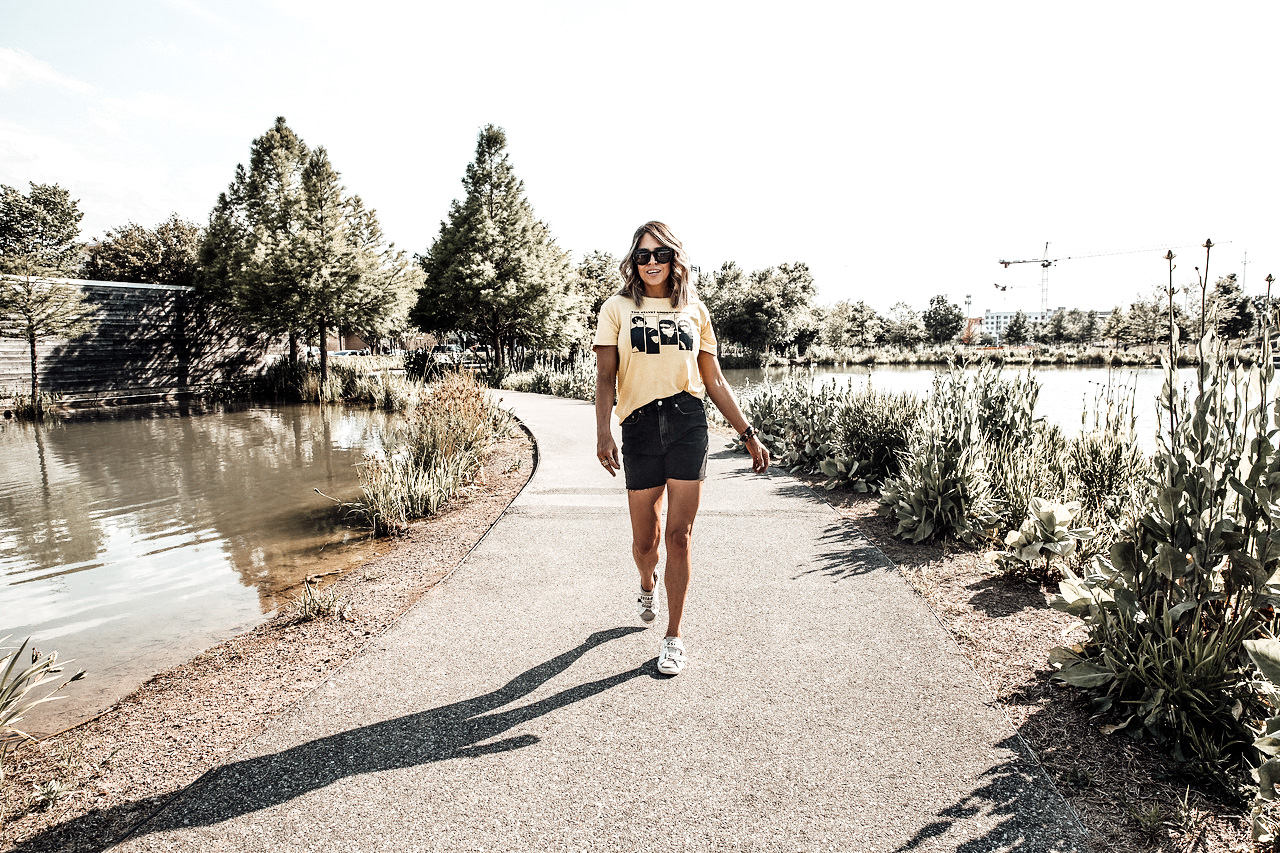 Yellow Velvet Underground band t-shirt with black cutoff denim shorts