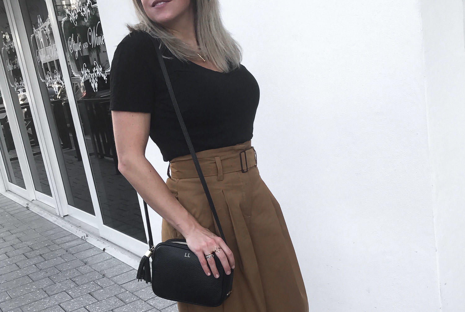 SEA high waisted wide legged pants // black Rag and Bone tee // Princetown Gucci slippers // Gigi New York cross body bag // Karen Walker round cat eye Super Duper sunglasses // Blogger Lindsey Lutz from Life Lutzurious styles one of fall's hottest trends: the paper bag waist.