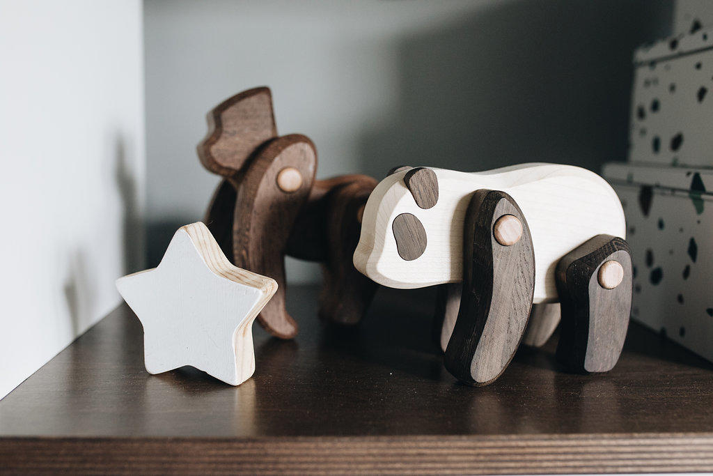 Need nursery inspiration? Birmingham Style blogger Lindsey Lutz from Life Lutzurious reveals her son Holden's mid-century modern nursery including these precious walnut and maple wooden toys. HOLDEN’S MID-CENTURY MODERN NURSERY REVEAL - Life Lutzurious; Looking to design a mid-century modern nursery? In this post, Blogger Life Lutzurious provides style tips and nursery design inspiration. Holden’s mid-century modern nursery reveal. From the camo wall to the gorgeous acrylic crib to our favorite rocker, this is hands down our favorite room in the house. Holden and I have spent SO many hours cuddling, dancing, and bonding in this perfect little palace for our perfect little prince. Click to see the nursery!