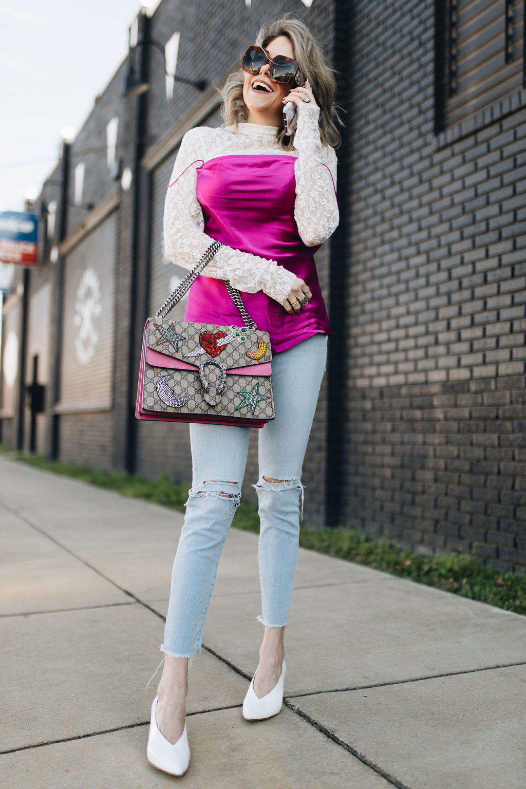 Looking for GIRLY GIRL Valentine's Day outfit ideas? Style Blogger Life Lutzurious styles this GORG pink and lace top, Gucci shoulder bag frayed skinny jeans, and white pointy toe heels.